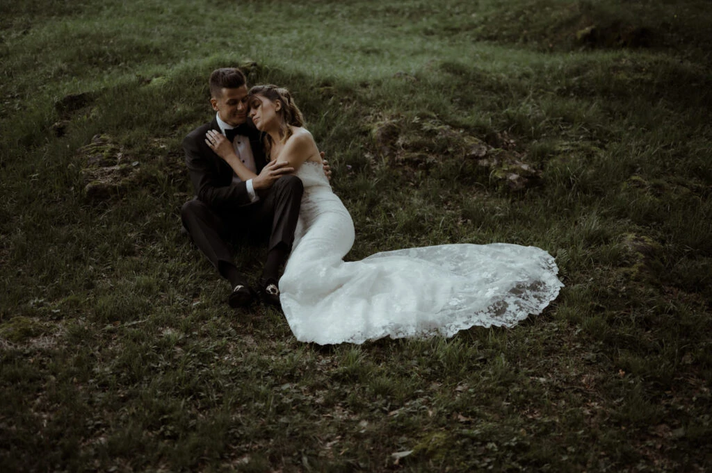 Bride and groom hugging on a green grass | Questions to ask a wedding photographer